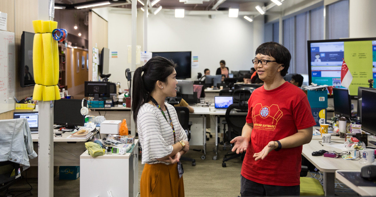 Two co-workers having a conversation in the office