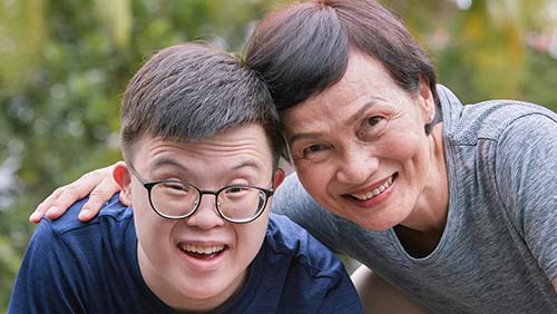 Mother and son holding each other and smiling happily