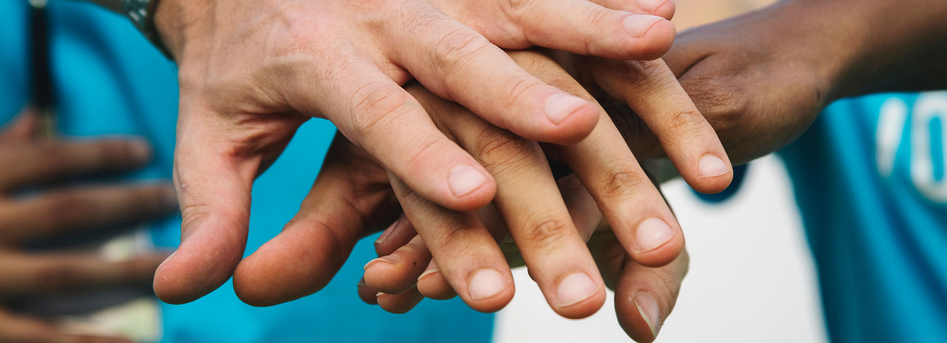 A group of volunteers holding hands together