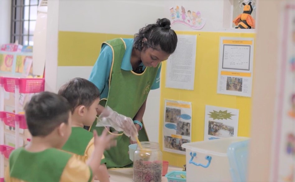 A teacher assistant with her pre-schoolers. A teacher assistant with her pre-schoolers.