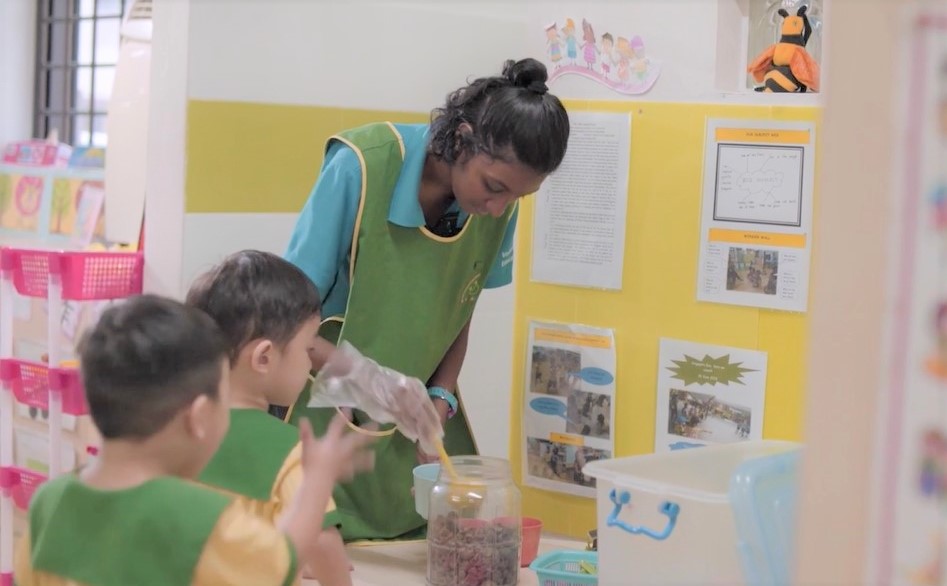 A teacher assistant with her pre-schoolers.