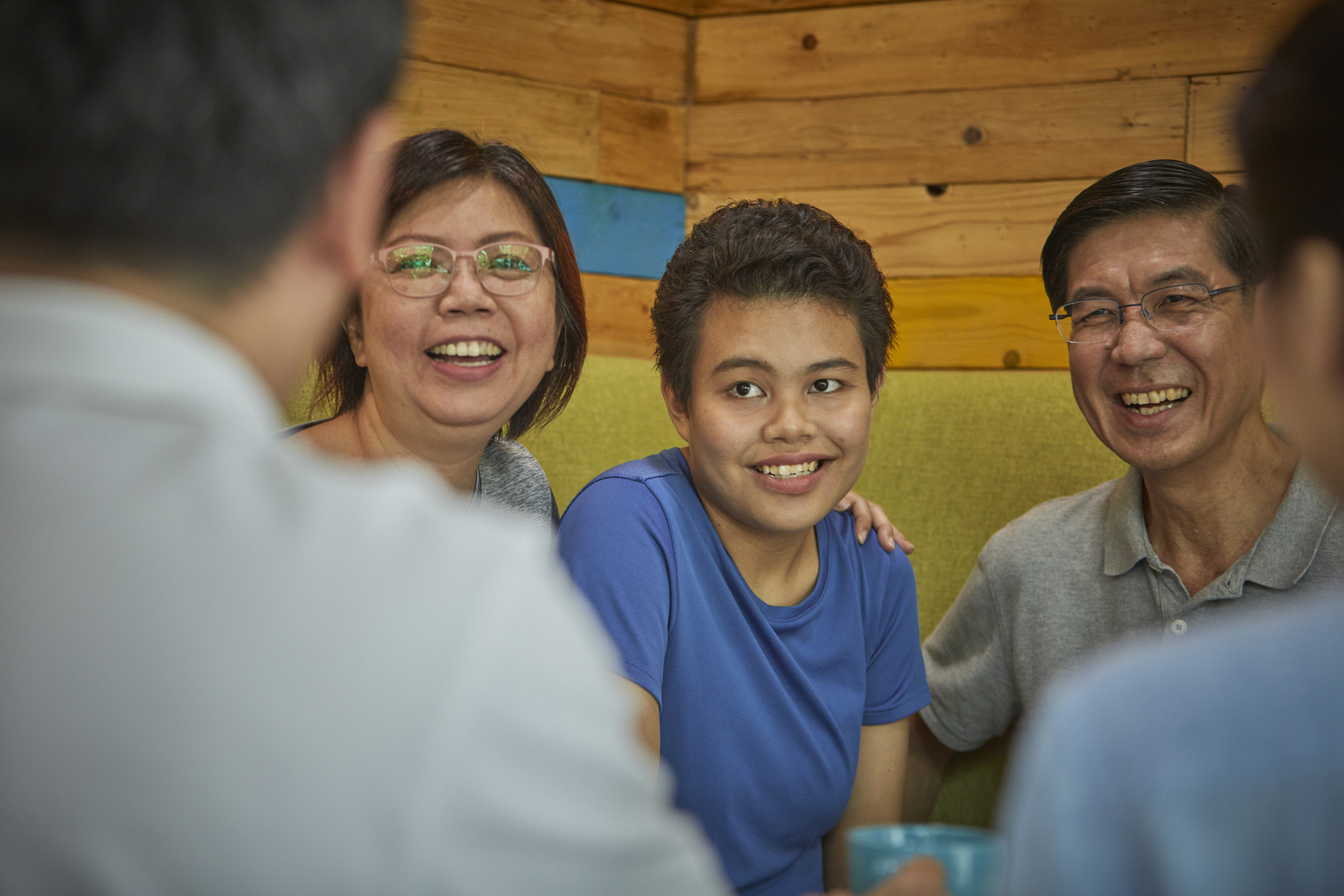 Caregivers and their daughter enjoying their engagement with SG Enable employees.