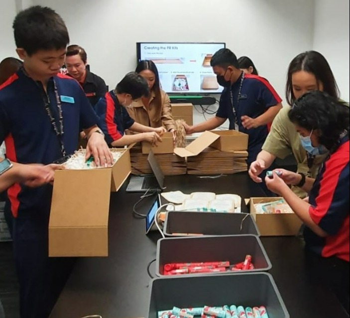 Students helping to pack PR kits, with the guidance of Sephora and school staff