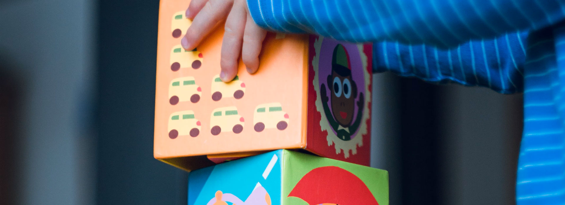 A child stacking blocks