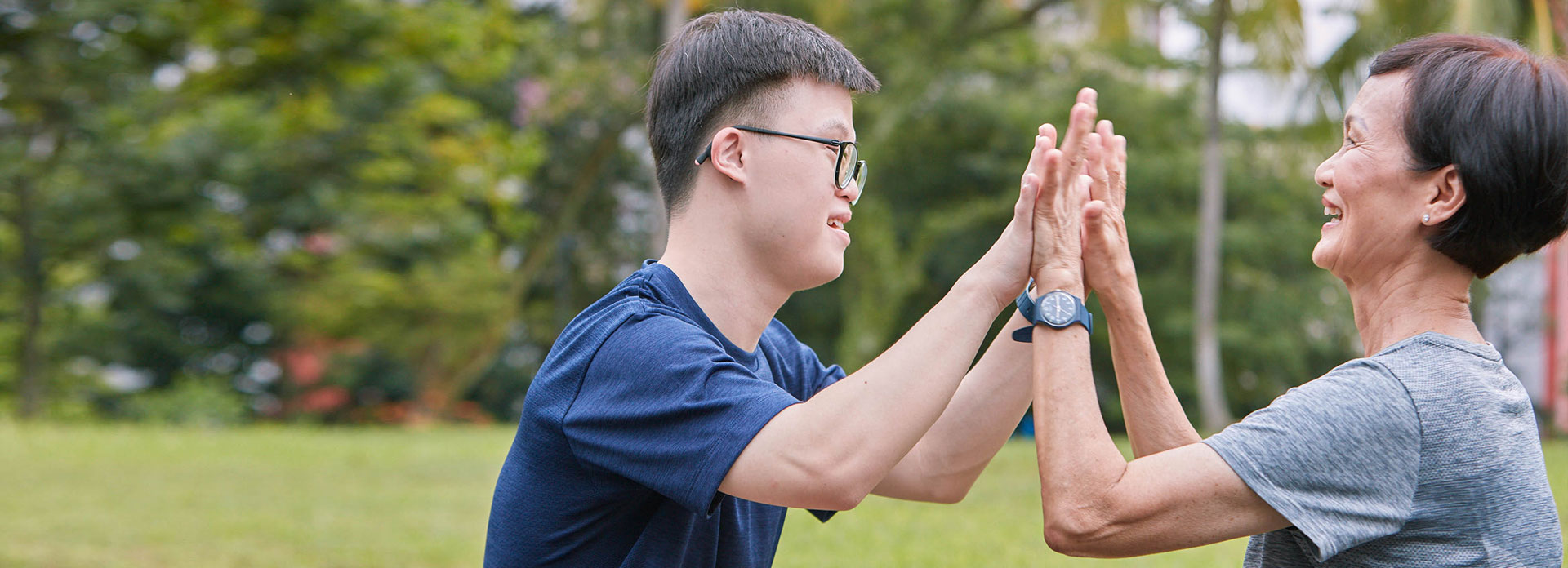 A mother and son high fiving each other